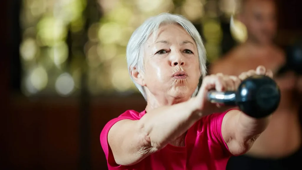 Toning Bingo Wings: Effective Exercises and Tips for Achieving Sleeker Arms 2 Person performing arm exercises with dumbbells Nantwich